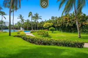 a park with palm trees and a pathway at New 2BR/2BA Nuevo Vallarta Condo | Pool, Beach in Nuevo Vallarta