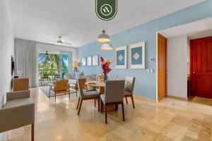 a dining room and living room with a table and chairs at New 2BR/2BA Nuevo Vallarta Condo | Pool, Beach in Nuevo Vallarta