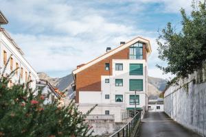 a house on a street with mountains in the background at adrimarcangas in Cangas de Onís
