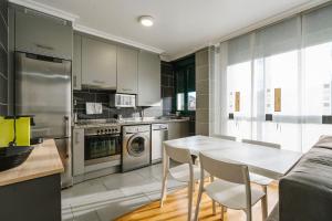 a kitchen with a table and chairs in a room at adrimarcangas in Cangas de Onís