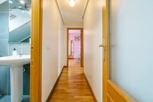 a hallway leading to a bathroom with a sink at adrimarcangas in Cangas de Onís +34 photos