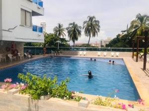 a person swimming in the pool at a hotel at Cartagena Sotavento Laguito in Cartagena de Indias