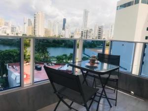 a table and chairs on a balcony with a view of the city at Cartagena Sotavento Laguito in Cartagena de Indias