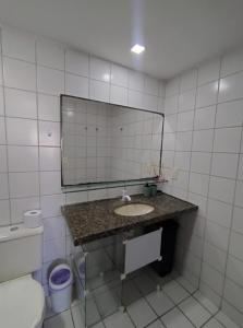 a bathroom with a sink and a mirror and a toilet at AV80101 - Aquaville Térreo - Porto das Dunas - CEARÁ in Aquiraz +44 photos