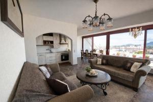 a living room with two couches and a table at Royal stylish view apartment in Koropi