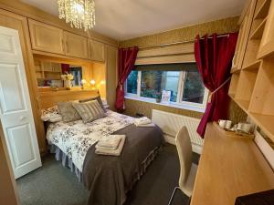 a small bedroom with a bed and a window at Station Approach Solihull Cabin Stays in Solihull