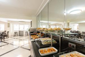 a buffet line with many different types of food at Hotel Amalia by Plaza Xavier in São Paulo