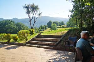 a man sitting on a bench looking at some stairs at Hotel Ibaigune in Murueta +54 photos