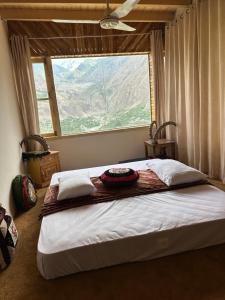 a bedroom with a bed with a large window at KOH E QAF HUNZA in Hini