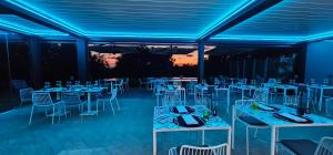 a room with tables and chairs and blue lights at Tenuta Bellelli in Castellabate