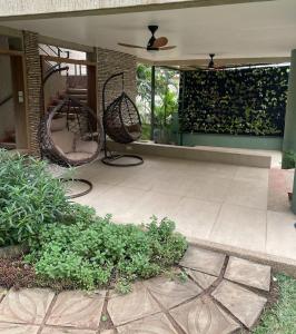 a patio with two chairs sitting on a porch at Lush Garden Chalet in Afiaman