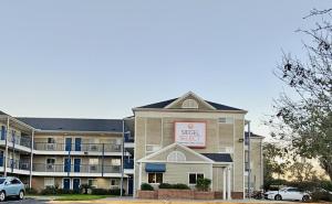 a hotel with a sign on the side of a building at Siegel Select Orange Park in Orange Park