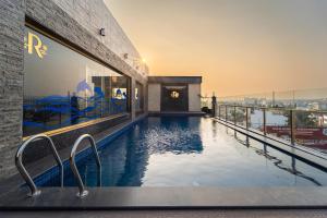 a swimming pool on the roof of a building at Ratan International in Pondicherry