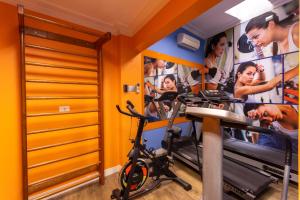 a room with a gym with posters on the wall at Hotel Amalia by Plaza Xavier in São Paulo