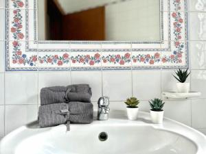 a bathroom sink with towels and a mirror at Panoramic Ocean View Villa in Is-Swieqi +17 photos