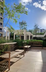 two wooden benches sitting on a patio at Apto 2/4 com Wi-Fi, TV, piscina e garagem | 1402 in Campinas