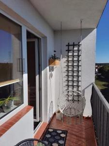 a balcony with a swinging chair on a porch at Mazury Witaj in Ostróda