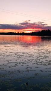 a sunset over a large body of water at Mazury Witaj in Ostróda