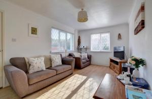 a living room with a couch and a table at 2 Bed in Croyde oc-sandc in Croyde