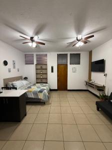 a bedroom with a bed and a ceiling fan at AeroloftGT in Estación Pamplona
