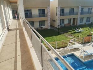 a balcony of a building with a swimming pool at Departamento 2 ambientes complejo Marlu in Federación
