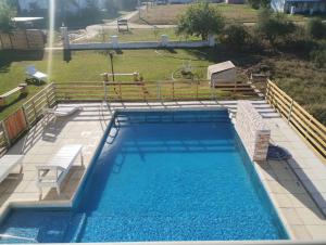 a large swimming pool in a yard with a playground at Departamento 2 ambientes complejo Marlu in Federación