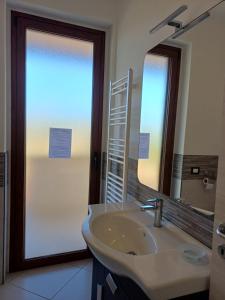 a bathroom with a sink and a mirror at Villa Rosetta in Villaggio Mosè +26 photos