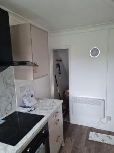 a kitchen with white cabinets and a counter top at 1 Bedroom Flat Ground Floor - Central Dunstable in Dunstable