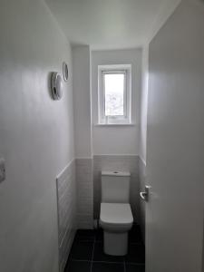 a bathroom with a toilet and a window at 1 Bedroom Flat Ground Floor - Central Dunstable in Dunstable