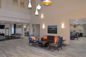 a lobby with a couch and chairs and a table at New Roads River Hotel in New Roads