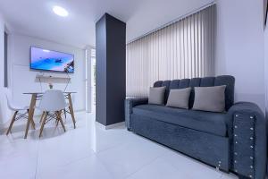 a living room with a blue couch and a table at hermoso apartasuite con la mejor ubicación in Cartago
