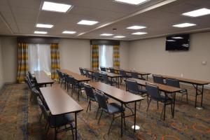 a classroom with tables and chairs in a room at New Roads River Hotel in New Roads