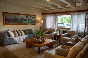 a living room with couches and a table at Grande Hotel Canela in Canela