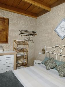 a bedroom with a bed and a shelf in it at Casita Sol in Villafamés +58 photos