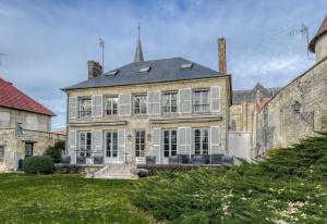 a large stone house with white shuttered windows at Maison de Charme a Rémy in Rémy