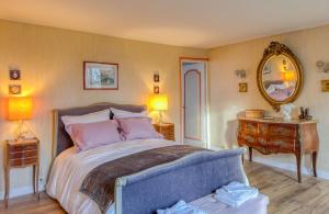 a bedroom with a bed and a dresser and a mirror at Maison de Charme a Rémy in Rémy