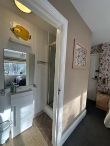 a bathroom with a sink and a mirror at Station Approach Solihull Cabin Stays in Solihull +39 photos