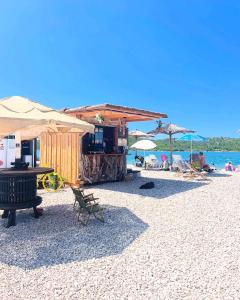 a beach with a bar and a grill on the beach at Apartman AS in Pirovac +35 photos