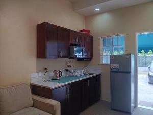 a kitchen with a refrigerator and a chair in it at Cozy Kingston Flat in Kingston