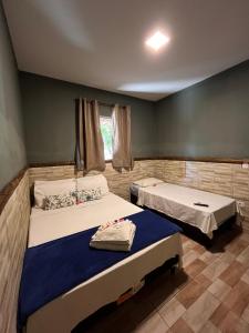 a room with two beds in a room at Mangut in São Miguel dos Milagres