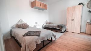 a bedroom with a bed and a wooden floor at FlexHome Stadtnatur Ferienwohnung in Lippstadt