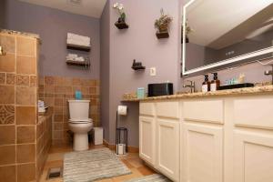 a bathroom with a toilet and a sink and a mirror at InHomeStays in Lakewood