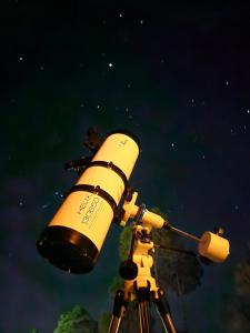 a telescope is looking at the stars in the sky at ilika Resort - A Boutique Stay 30 km from Devprayag in Pauri