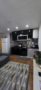 a living room with a couch and a kitchen at Moradia Belo horizonte in Alfena