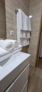 a bathroom with a sink and a mirror and towels at Moradia Belo horizonte in Alfena +29 photos