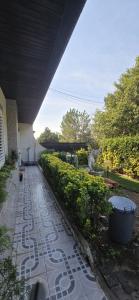 a walkway in a garden with a building at Moradia Belo horizonte in Alfena