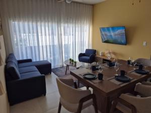 a living room with a dining room table and chairs at Turquesa depa in Cabo San Lucas