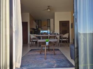 a living room with a table and a dining room at Turquesa depa in Cabo San Lucas