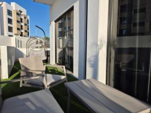a balcony with a chair and a table and a window at Turquesa depa in Cabo San Lucas