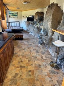 a living room with a large stone wall at Casa Roca in Arona